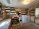 Laundry room with washer, dryer, shelving, and utility sink at 128 Lake Hazel Dr, Winter Haven, FL 33884