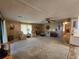 Spacious living room with light-colored carpet, comfortable seating and large windows at 128 Lake Hazel Dr, Winter Haven, FL 33884