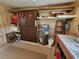 Storage room with shelving and water heater at 128 Lake Hazel Dr, Winter Haven, FL 33884