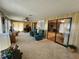 Bright sunroom with comfy seating and views to other rooms at 128 Lake Hazel Dr, Winter Haven, FL 33884