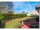 Spacious backyard with grassy area, hedge and patio at 1307 Lopez Ln, The Villages, FL 32159