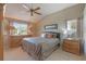 Spacious primary bedroom with wood furniture and ceiling fan at 1307 Lopez Ln, The Villages, FL 32159