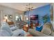 Living room with a blue accent wall, fireplace and comfortable seating at 1307 Lopez Ln, The Villages, FL 32159