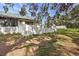 Home's fenced backyard with green grass and trees at 1313 Vine St, Leesburg, FL 34748