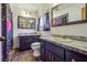 Bathroom with dark vanity, double sinks, and tile floor at 1313 Vine St, Leesburg, FL 34748