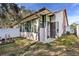 Back exterior view of house with sunroom and fenced yard at 1313 Vine St, Leesburg, FL 34748