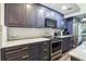 Modern kitchen with dark blue cabinets, stainless steel appliances and marble countertops at 1313 Vine St, Leesburg, FL 34748