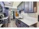 Modern kitchen with dark blue cabinets, stainless steel appliances and marble countertops at 1313 Vine St, Leesburg, FL 34748