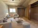 Cozy living room features neutral tones, a comfortable sofa, an armchair, a coffee table, and a window for natural light at 1313 Vine St, Leesburg, FL 34748