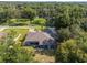 Aerial view showing a house with a large backyard and surrounding trees at 13819 Sw 109Th Ln, Dunnellon, FL 34432