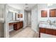 A bathroom featuring double sink vanities with granite countertops and modern fixtures at 13819 Sw 109Th Ln, Dunnellon, FL 34432