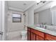 A bathroom featuring a marble shower/tub combo, toilet and a modern granite vanity at 13819 Sw 109Th Ln, Dunnellon, FL 34432