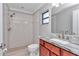 A bathroom featuring a tiled walk-in shower and modern vanity at 13819 Sw 109Th Ln, Dunnellon, FL 34432