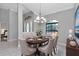 Elegant dining room with a chandelier, arched window, and a formal dining table at 13819 Sw 109Th Ln, Dunnellon, FL 34432