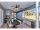 Screened patio with ceiling fan features a glass dining table with seating for eight guests at 13819 Sw 109Th Ln, Dunnellon, FL 34432