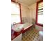 Bathroom with red accents, featuring a clawfoot tub and a pedestal sink at 1420 Old Mount Dora Rd, Eustis, FL 32726