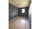 Small bedroom with dark-grey walls, tile floors, and a ceiling fan at 1420 Old Mount Dora Rd, Eustis, FL 32726