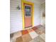 Inviting front door with a yellow frame and terracotta door at 1420 Old Mount Dora Rd, Eustis, FL 32726