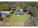 Aerial view of a green home on a fenced large lot at 1511 Moss Ave, Leesburg, FL 34748