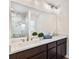 Elegant bathroom featuring double sinks, quartz countertops, and a marble tiled shower at 1511 Moss Ave, Leesburg, FL 34748