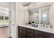 Modern bathroom features a double sink vanity, sleek fixtures, and a beautifully tiled shower with glass door at 1511 Moss Ave, Leesburg, FL 34748