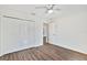 This bedroom has a ceiling fan, wood-look vinyl floors, a large closet with white paneled doors at 1511 Moss Ave, Leesburg, FL 34748