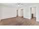 Bright bedroom with hardwood floors, ceiling fan and multiple doorways at 1511 Moss Ave, Leesburg, FL 34748