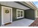 Inviting front porch features a neutral door with wreath and a welcome mat at 1511 Moss Ave, Leesburg, FL 34748