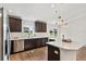 Bright kitchen featuring stainless steel appliances, dark wood cabinets, and a large island at 1511 Moss Ave, Leesburg, FL 34748