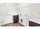 Functional laundry room with shelving, white countertop, and washer/dryer hookups at 1511 Moss Ave, Leesburg, FL 34748