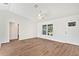 Bright living room features vaulted ceilings, wood-look floors, and a modern ceiling fan at 1511 Moss Ave, Leesburg, FL 34748