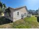 Home's side view, showcasing a grassy yard at 16154 Magnolia Hill St, Clermont, FL 34714