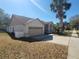 Side view of house, showing garage and landscaping at 16154 Magnolia Hill St, Clermont, FL 34714