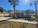 Single-story home with a two-car garage and palm trees at 16154 Magnolia Hill St, Clermont, FL 34714