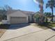 House's front view, showing garage and driveway at 16154 Magnolia Hill St, Clermont, FL 34714