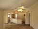 Kitchen features wood cabinets and view to living room at 16154 Magnolia Hill St, Clermont, FL 34714