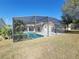 Screened-in pool with patio furniture at 16154 Magnolia Hill St, Clermont, FL 34714