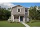 Two-story craftsman style home with gray siding, blue door, and landscaped lawn at 16908 Hamlin Oasis Loop, Winter Garden, FL 34787