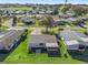 House and neighborhood aerial view, showcasing golf course proximity at 1711 Lilly Ln, The Villages, FL 32159