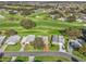 Wide aerial view showing house location within the community and golf course at 1711 Lilly Ln, The Villages, FL 32159