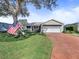 Exterior view of single story home with garage at 1711 Lilly Ln, The Villages, FL 32159