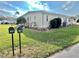 Side yard of a yellow single story home with landscaping at 180 Hibiscus Way, Leesburg, FL 34748