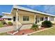 Covered patio area with landscaping and walkway at 180 Hibiscus Way, Leesburg, FL 34748