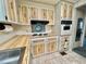 Retro kitchen with wood cabinets, built-in oven, and a cooktop at 180 Hibiscus Way, Leesburg, FL 34748