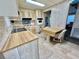 Kitchen with wood cabinets, a breakfast bar, and tile floor at 180 Hibiscus Way, Leesburg, FL 34748