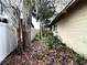 Narrow side yard with mature trees and a wooden fence at 1803 Ne 29Th Pl, Ocala, FL 34479