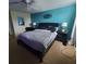 Bedroom with black headboard and striped bedding at 2287 Victoria Dr, Davenport, FL 33837