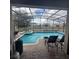 Screened pool and spa with lounge chairs at 2287 Victoria Dr, Davenport, FL 33837