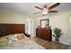 Bright bedroom with a wood-framed bed, matching dresser, and light-toned walls at 24450 Ne 127Th St, Salt Springs, FL 32134