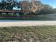 Street view of single story home with an updated fence and landscaping at 24450 Ne 127Th St, Salt Springs, FL 32134